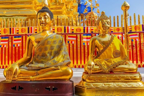 Gilded seated Buddha figures with orange cloaks, Wat Phra That Doi Suthep temple complex, Chiang