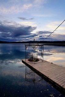 Table with two chairs on a pier at Lac d'Aiguebelette, Great Natural Lake, Aiguebelette-le-Lac,