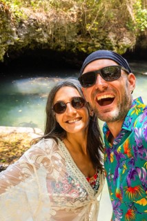 Portrait selfie couple man woman travelers wear vibrant tropical shirt takes pose in Baraka Natural