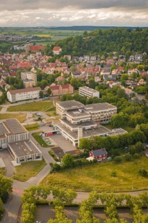Aerial view of an urban landscape with a view of a large building and surrounding houses, new IGZ,