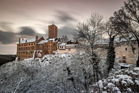 Castle with snow-covered trees and tower at dusk, The Wartburg near Eisenach in Thuringia