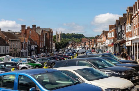 High Street congested with traffic, parked cars, vehicles, Marlborough, Wiltshire, England, UK