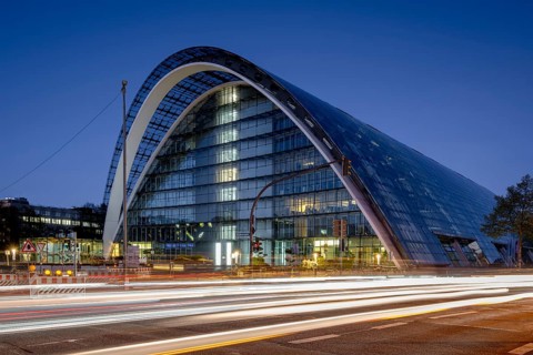 BBCC Berliner Bogen Conference Center at blue hour with light strips of vehicles in the foreground,