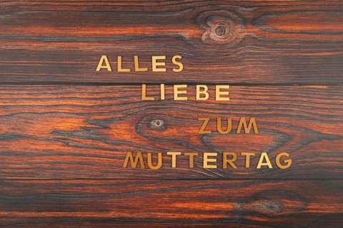 Letters on wooden surface with 'Happy Mother's Day' rustic style