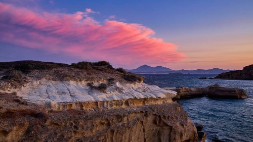 Mauve sky at sunset over rocky coast and sea, Aspragremna, White Cliffs, Mavorspilia Beach, Kimolos