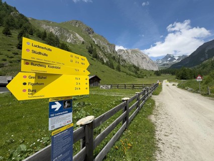 Signage signs with route information for hikers next to the beginning of the hiking trail in