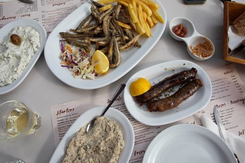 Sfakian sausages, eggplant puree, tzaziki and fried sardines, traditional dish in Crete, Greece
