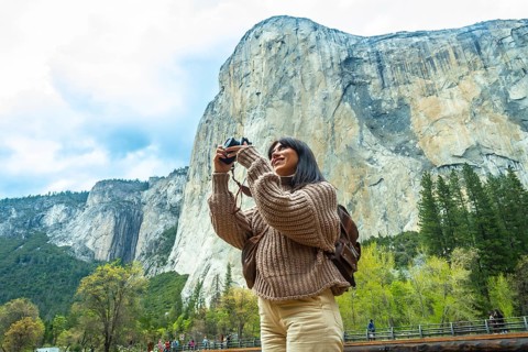 Woman traveler enjoying the natural beauty of yosemite national park, capturing the iconic el