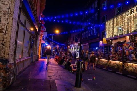 People sitting and walking on an atmospheric street at night, nightlife, Dublin, Ireland