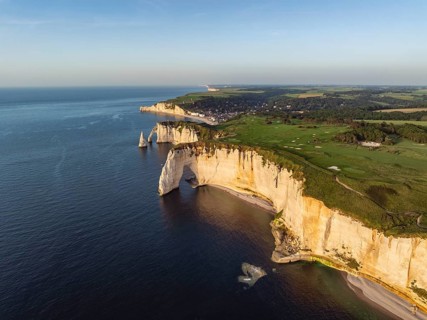 Aerial view of the rock gate La Manneporte in the evening sun, behind it the Porte d'Aval rock