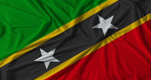 Saint Kitts and Nevis flag with fabric texture background. National flag of Saint Kitts and Nevis