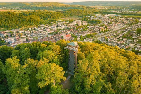 A panoramic view of an observation tower in the forest with a city in the background, Tiengen,