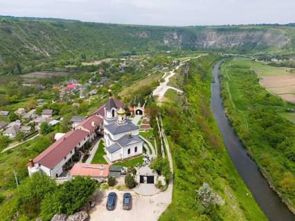 Aerial view of a church overlooking a gorge and a river in a green landscape, aerial view, St.