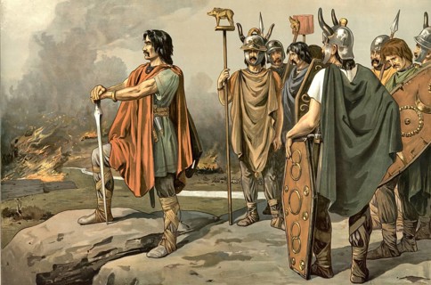 Vercingetorix, depicted as a Gaulish leader standing on a rock and looking at a burning