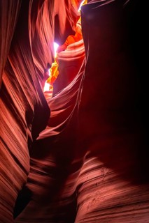 Antelope canyon slot canyon showing narrow sandstone formations with swirling lines and rich