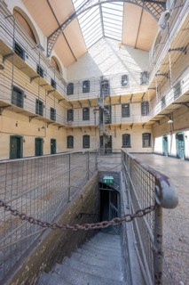 Stairway in an old building with surrounding gallery floors and open skylight, Kilmainham Gaol