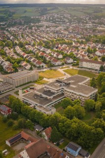 Bird's-eye view of an urban landscape with numerous buildings and green areas, new IGZ, Herrenberg