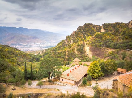 Aerial view down to buildings of orthodox monastery Shio-Mgvime. Georgia