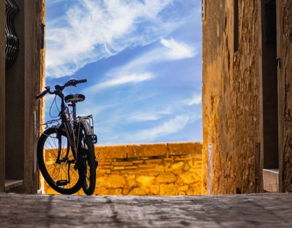 Parked bike in a small alley, Pienza, Tuscany, Italy