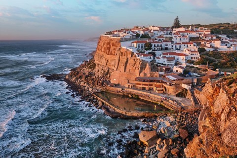 Stunning seaside village of Azenhas do Mar in Portugal as the sun sets over the Atlantic Ocean. The