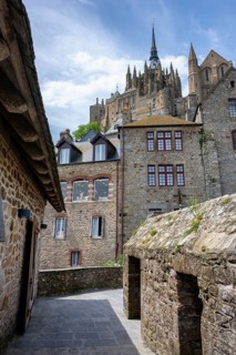 View through a historic alley of Mont-Saint-Michel Abbey, tourist attraction, UNESCO World Heritage