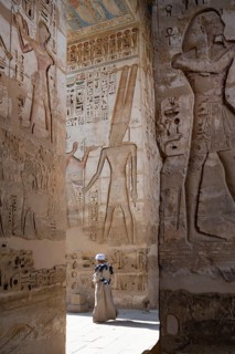 Luxor, Egypt. January 6th 2026. A tour guide walks past reliefs and hieroglyphs inside Medinat