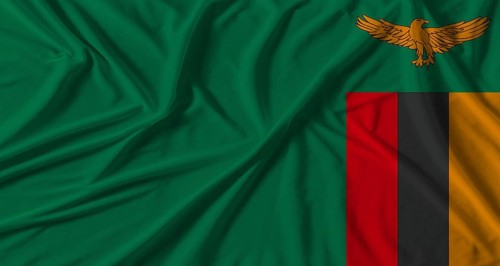 Zambia flag with fabric texture background. National flag of Zambia with cloth texture