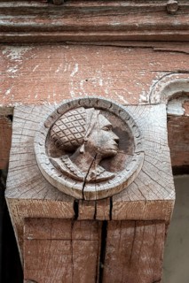Historic wood relief, profile portrait of a woman on a support beam of a historic half-timbered