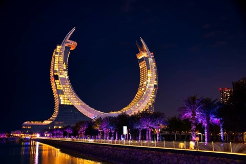 Doha, Qatar - january 6th, 2026: katara Towers at night in Lusail, Qatar. Tourists stroll along the