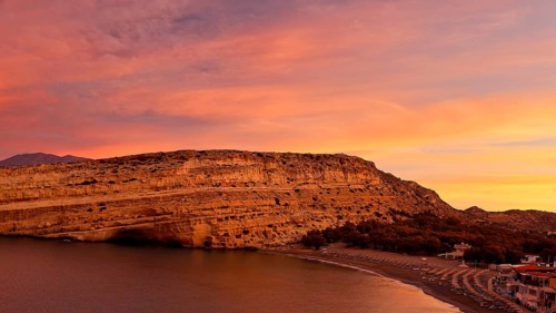 Sunrise on a coast with rocks, quiet beach and calm sea, Matala, south coast, Crete, Greek Islands,
