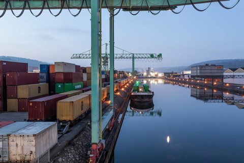 8.5.2026: Container terminal at Stuttgart harbor with cranes and barge under moonlight. Stuttgart,
