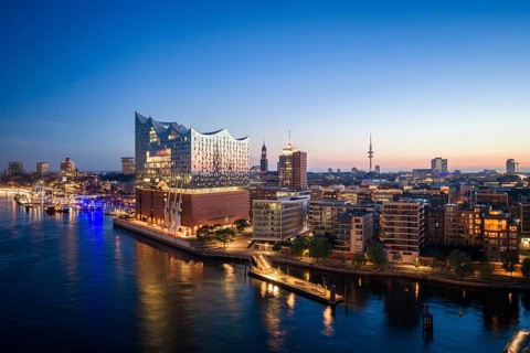 Aerial view of sunrise on the Elbe with Elbe Philharmonic Hall and reflections in the glass façade,