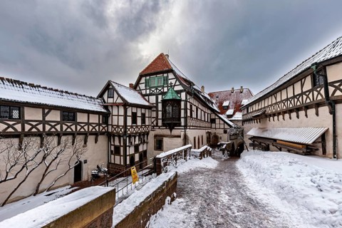 Snowy courtyard of a half-timbered castle with wintry sky, The Wartburg near Eisenach in Thuringia