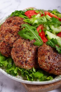 Fried cutlets, mixed minced meat, with vegetable salad, homemade, top view, no people