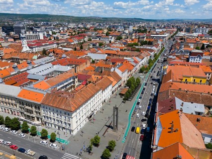City view with red roofs along a main road under a blue sky, aerial view, view of the Bulevardul