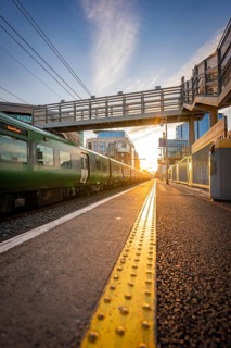 View along a rail with bridge at sunset, surrounded by modern buildings, Dockland, Dublin, Ireland