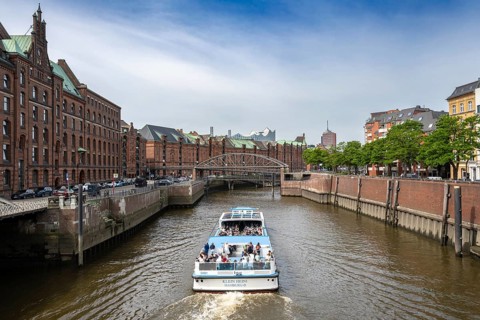 Passenger ship Klein Heini on the customs canal in Hamburg's Speicherstadt with Brooks Bridge and