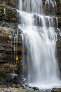 Adventure, Little hiker under large Cascata di Mezzo waterfall, long exposure, Vallesinella,