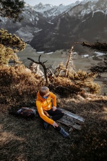 Hiker in the Allgäu at sunset in spring on the Zirmgrat near Pronten in the Allgäu