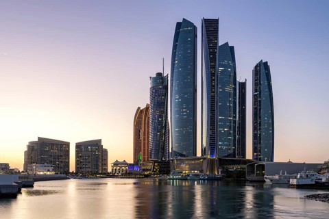 Abu Dhabi Skyline Etihad Towers skyscrapers at night in Abu Dhabi, United Arab Emirates
