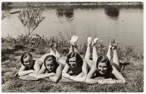 Bathing, swimwear, woman, leisure, fun, summer, Four woman in swimming suits lie belly down by the