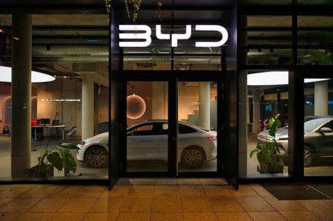 Night shot, view of showroom through shop window, sales exhibition of the car brand BYD Build Your