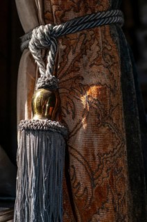 Cord with shiny golden knob holds old curtain together, Chapslee Hotel, former summer residence of