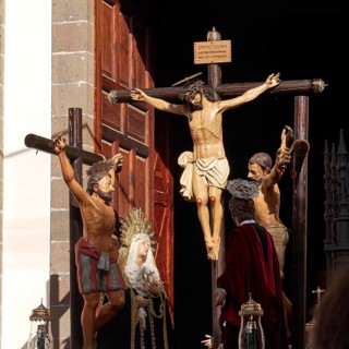 Religious figures on crosses in a church door with sunlight, Good Friday procession, Easter, UNESCO