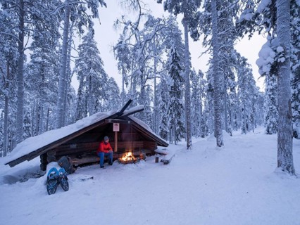 Rest at a fireplace, snowshoe hike. Luosto, Lapland, Finland