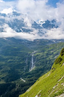 Picturesque mountain landscape with Schmadribachfall waterfall and mountain peaks, Bernese Alps,