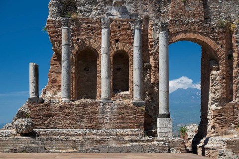 View of columns, ancient theatre, Etna in the background, Taormina, Sicily, Italy