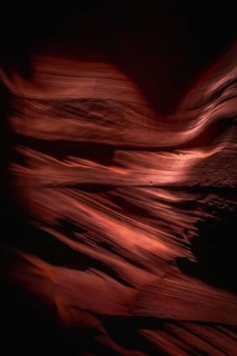 Antelope canyon's curving sandstone slot canyon walls creating flowing abstract patterns, sculpted