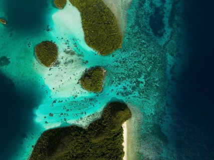 Aerial view of tropical islands and turquoise lagoons from above, Wayag Archipelagio, West Papua,