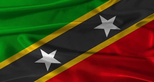 Flag of Saint Kitts and Nevis with fabric textured background. Close up of National flag of Saint